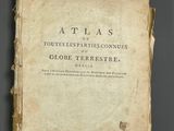 a close up of a book on a table with a black background