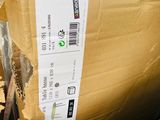a cardboard box with a sticker on it sitting on the floor