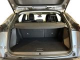 the back of a car with its trunk open and the back seats down