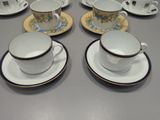 many cups and saucers on the table ready to be served