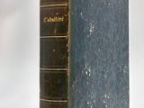an old book sitting on top of a white table next to a white wall