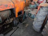 an old tractor that is sitting in a garage