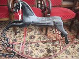 a rocking horse that is sitting on a rug