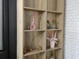 a wooden shelf that has some plants on top of it