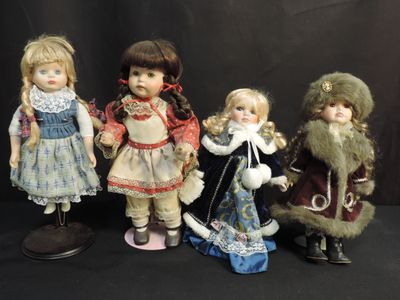 three dolls of different sizes and colors are posed in front of a black background
