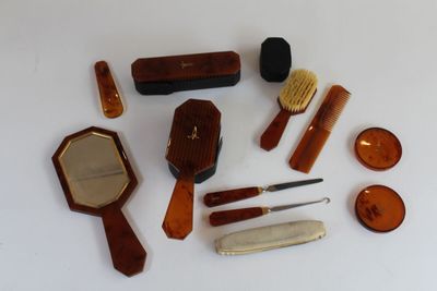 many different types of hair brushes and combs laid out on a table