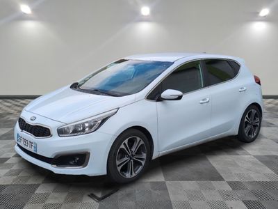 a white car parked on a checkered floor in a garage