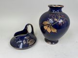 a blue vase and a small blue vase on a table