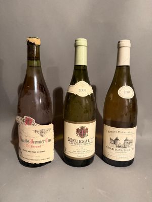 three bottles of wine are lined up on a gray surface