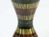 a vase that is sitting on a white surface