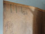 a brown leather case that has a number on it