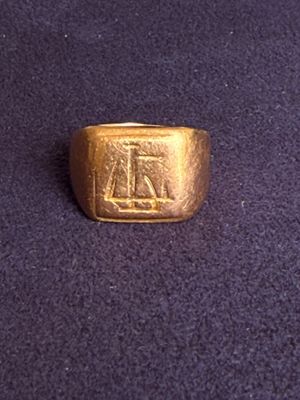 an image of a gold ring on a purple surface