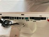 a close up of a laptop on a stand with wires