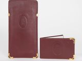 a brown leather wallet with a gold clasp and a card holder