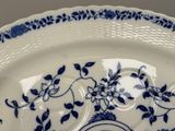 a blue and white plate with a clock on it