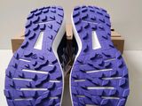 a close up of a pair of purple shoes on a white surface