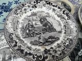 a plate with a picture of a couple and a duck on it