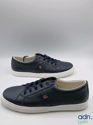 a pair of blue sneakers with white soles on a white background
