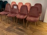 several chairs are lined up in a row on a wooden floor