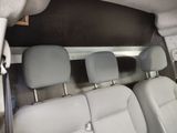 four seats in the back of a van that is empty