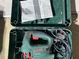 a green box with tools in it sitting on the floor