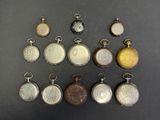 many different types of pocket watches on the table