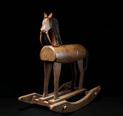 a wooden rocking horse with a horse head on it