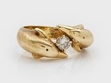 a close up of a gold ring with a diamond in the middle