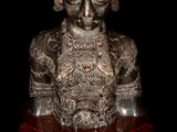 an image of a statue of a woman with a bird on her head