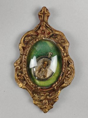 an image of a gold frame with a picture of a woman in a green dress
