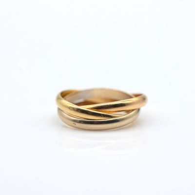 a close up of a gold ring on a white surface