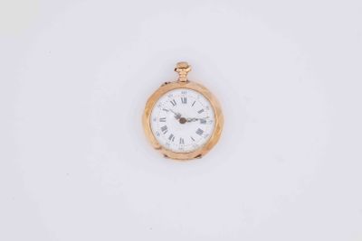 a small gold pocket watch with roman numerals on the face
