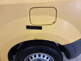 a close up of a yellow truck with a black rim