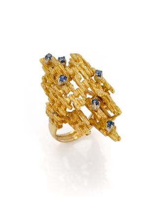 a close up of a gold ring with blue stones on it