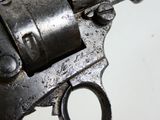 a close up of a gun on a white surface