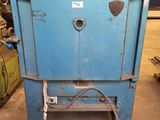 a blue machine that is sitting in a warehouse