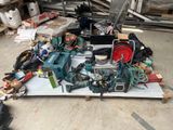 a pile of tools on a pallet in a garage