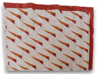 an orange and white quilt on a white background with a red border
