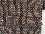 a close up of a brown knitted purse with a brown leather tag