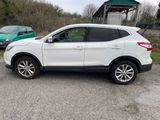 a white suv parked in a parking lot next to a green car