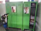 two green lockers with pictures on them in a room