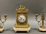 three different types of clocks on display on a table
