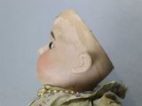 a close up of a doll with a hat on