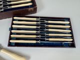a lot of knives in a wooden box with a knife holder