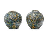 pair of blue and green vases with floral designs on them