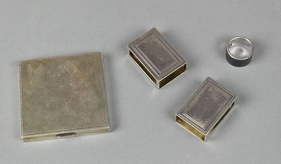 three small silver boxes sitting next to each other on a table
