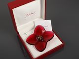 a red flower shaped ring in a red box