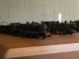 un circuit de train miniature posé sur une table en bois et équipé d'une télécommande