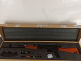 an open box with a gun inside of it on a table