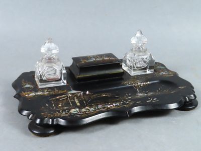 a black and gold desk set with two salt and pepper shakers on it